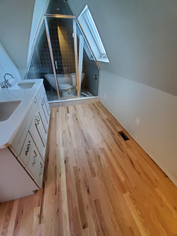 2-1/4" Red Oak with water-based finish 3 Red Oak flooring with water-based finish in a finished attic en-suite