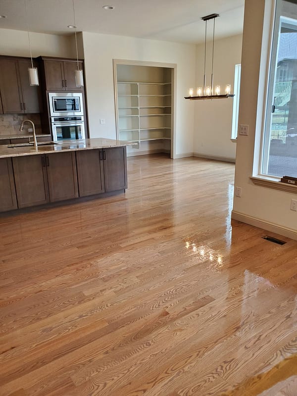 3-1/4" Red Oak stained top with polyurethane finish 3 Red Oak stained flooring with polyurethane finish in a modern kitchen