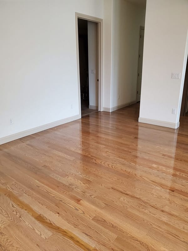 3-1/4" Red Oak stained top with polyurethane finish 2 Red Oak stained flooring with polyurethane finish in a modern kitchen