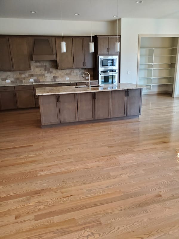 3-1/4" Red Oak stained top with polyurethane finish 1 Red Oak stained flooring with polyurethane finish in a modern kitchen