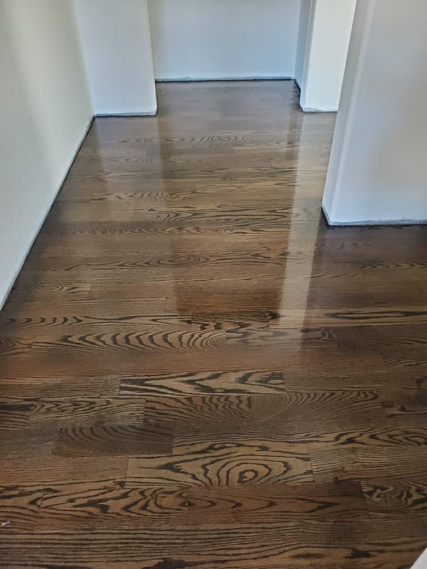 3-1/4 Red Oak stained driftwood with polyurethane finish Red Oak stained driftwood with polyurethane finish in broad hallway facing sliding doors
