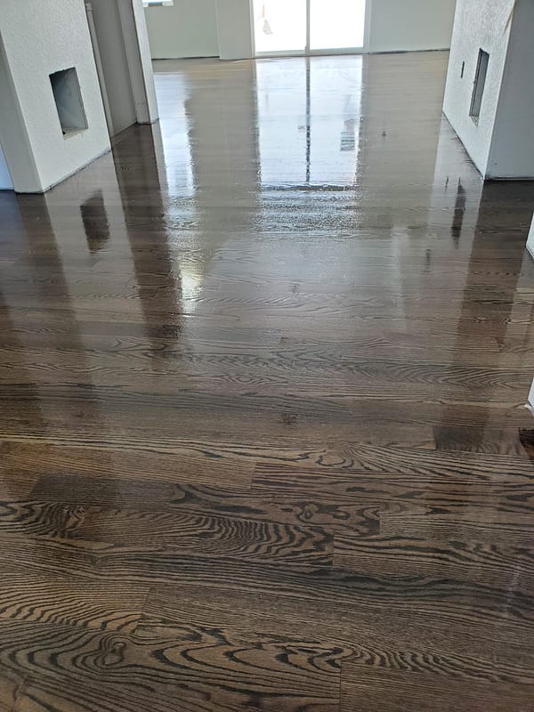 3-1/4 Red Oak stained driftwood with polyurethane finish Red Oak stained driftwood with polyurethane finish in broad hallway facing sliding doors