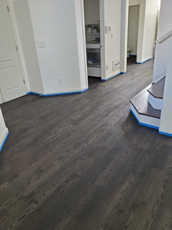 4" Red Oak stained Ebony Red Oak stained Ebony flooring on angled stairs with white risers