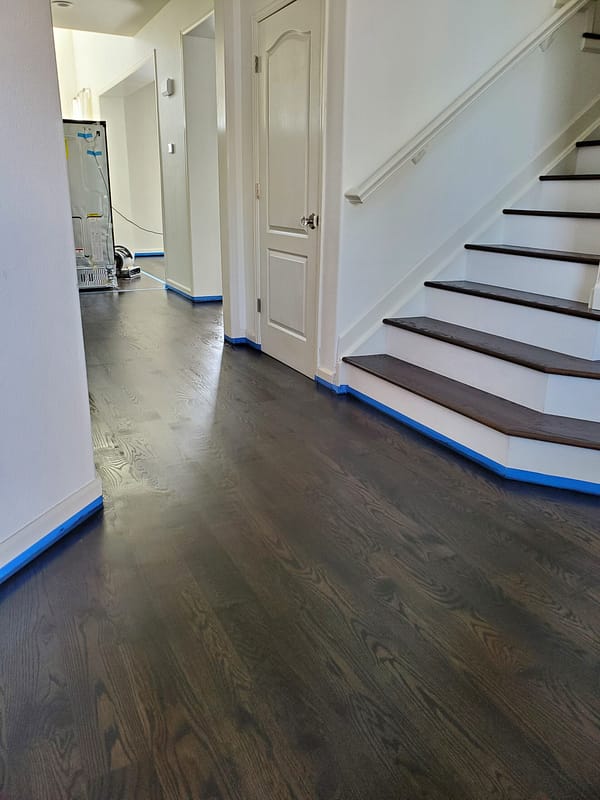 4" Red Oak stained Ebony 4 Red Oak stained Ebony flooring on angled stairs with white risers