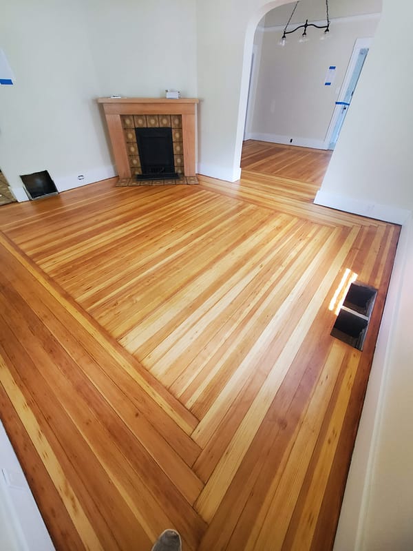 3" Fir with natural finish Log Cabin border 1 Fir flooring with natural finish and Log Cabin border with a fireplace and archway