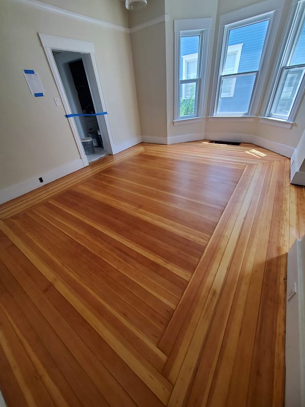 3" Fir with natural finish Log Cabin border 3 Fir flooring with natural finish and Log Cabin border in a bay window