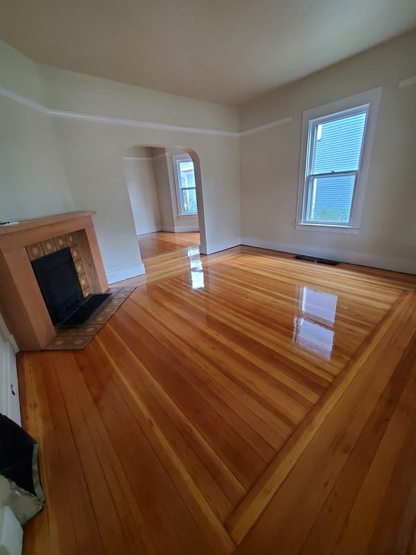 3" Fir with natural finish Log Cabin border 6 Fir flooring with natural finish and Log Cabin border with a fireplace and archway