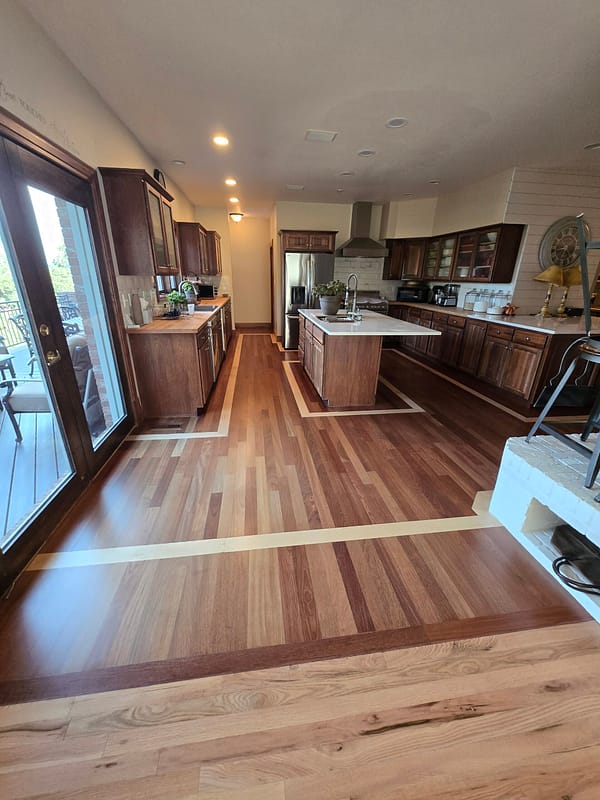 3-1/4" Brazilian Cherry with a Maple border inlay 2 Brazilian Cherry flooring with varying tones and a Maple border inlay in a rustic modern kitchen
